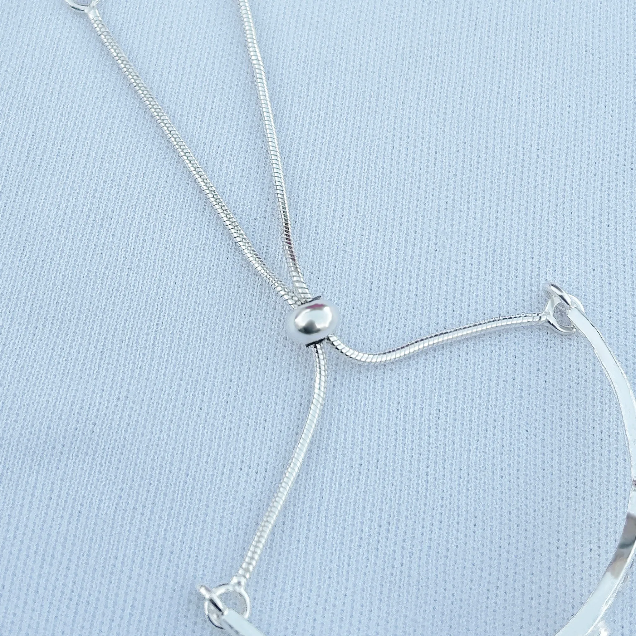 Silver bracelet with bold red stone and one-of-a-kind design.